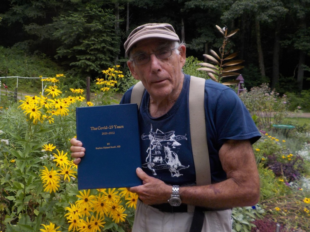 A photograph of author Stephen Soreff holding a copy of his book